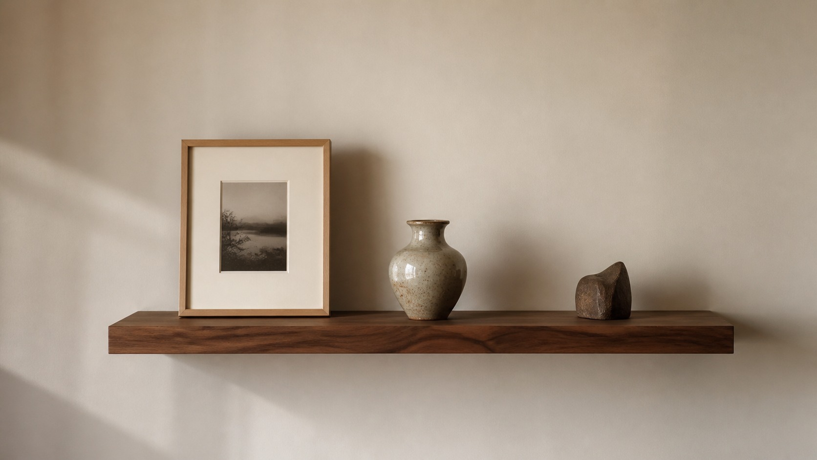 Sentimental objects on a floating shelf Floating shelf with three sentimental objects displayed against a calm neutral wall with generous space around them. | Sky Rye Design Floating shelf with three sentimental objects displayed against a calm neutral wall with generous space around them.
