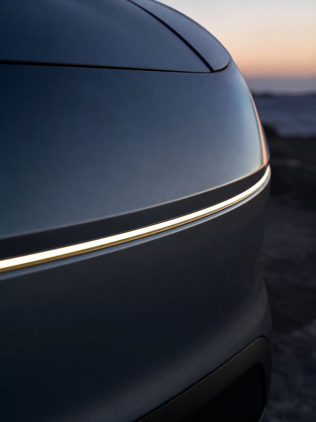 EV grilleless front fascia surface detail A close view of a smooth grilleless EV front fascia at dawn, with a clean reflection line across the surface. | Sky Rye Design A close view of a smooth grilleless EV front fascia at dawn, with a clean reflection line across the surface.