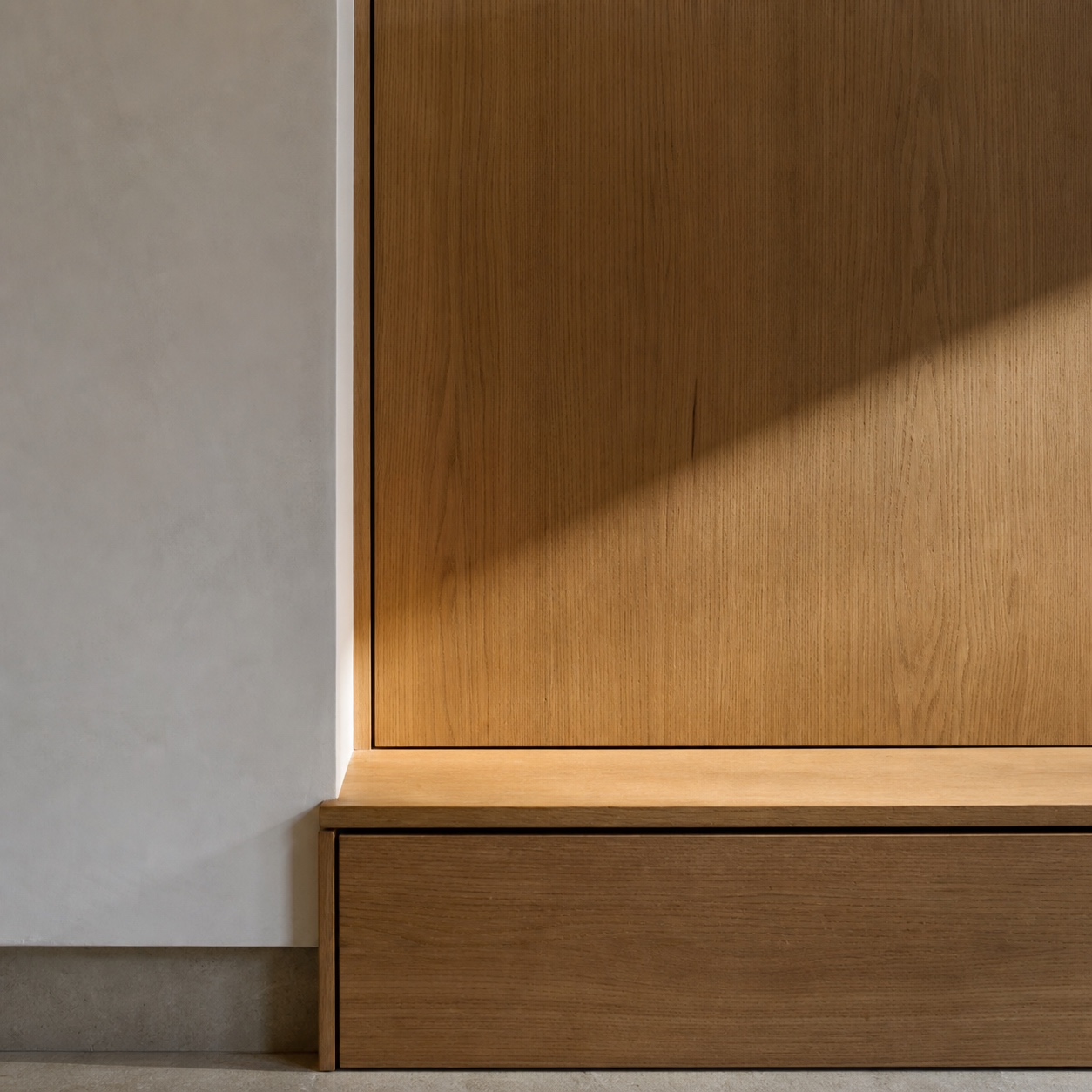 Finished millwork reveal with precise natural light Completed millwork corner with precise reveal lines and natural light across the wood surface. | Sky Rye Design Completed millwork corner with precise reveal lines and natural light across the wood surface.