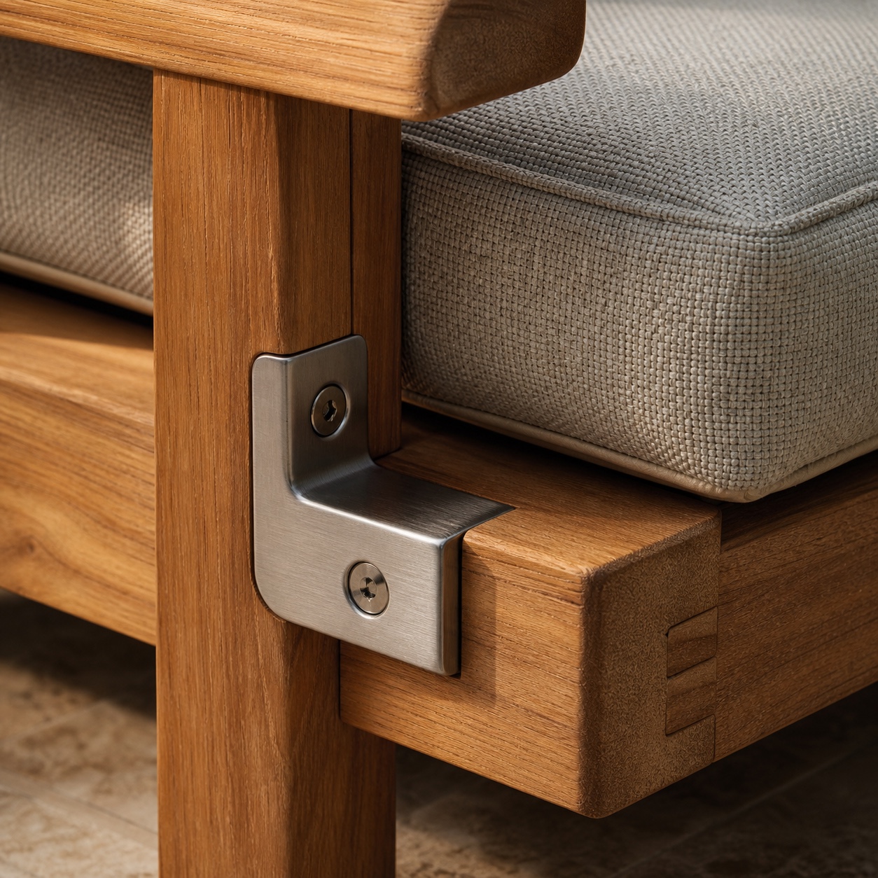 Close-up of teak joinery, brushed marine-grade hardware, and woven outdoor cushion fabric