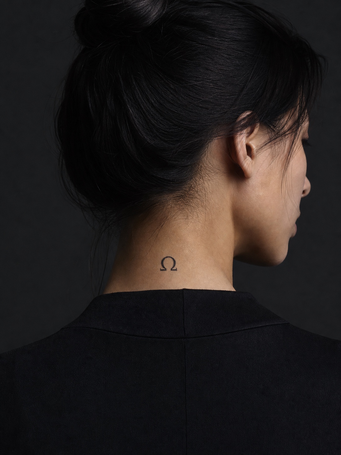 Omega Greek letter neck tattoo Single Omega symbol tattoo at the nape of the neck in clean black ink. | Sky Rye Design Single Omega symbol tattoo at the nape of the neck in clean black ink.