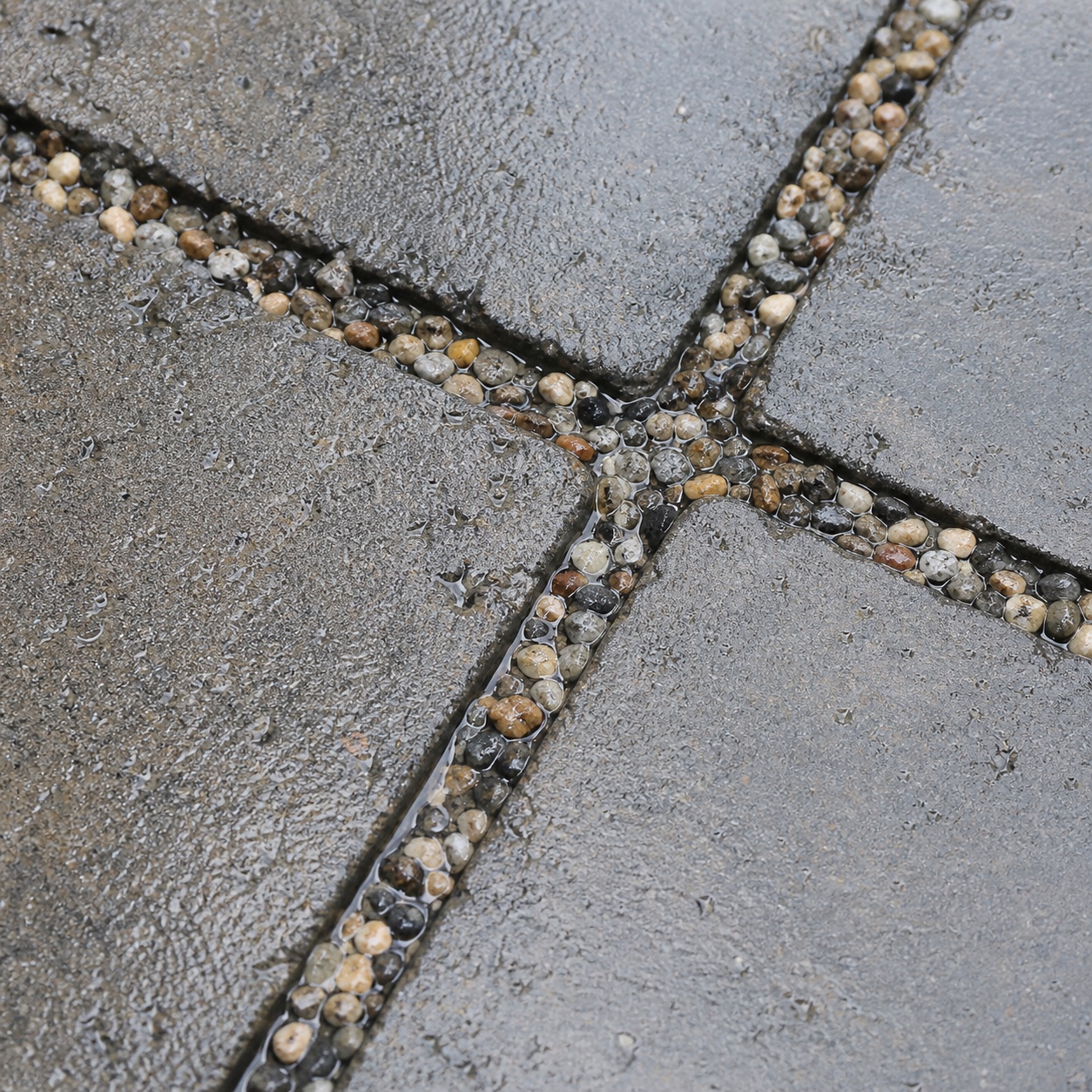 Wet permeable pavers with gravel joints that let water soak through.