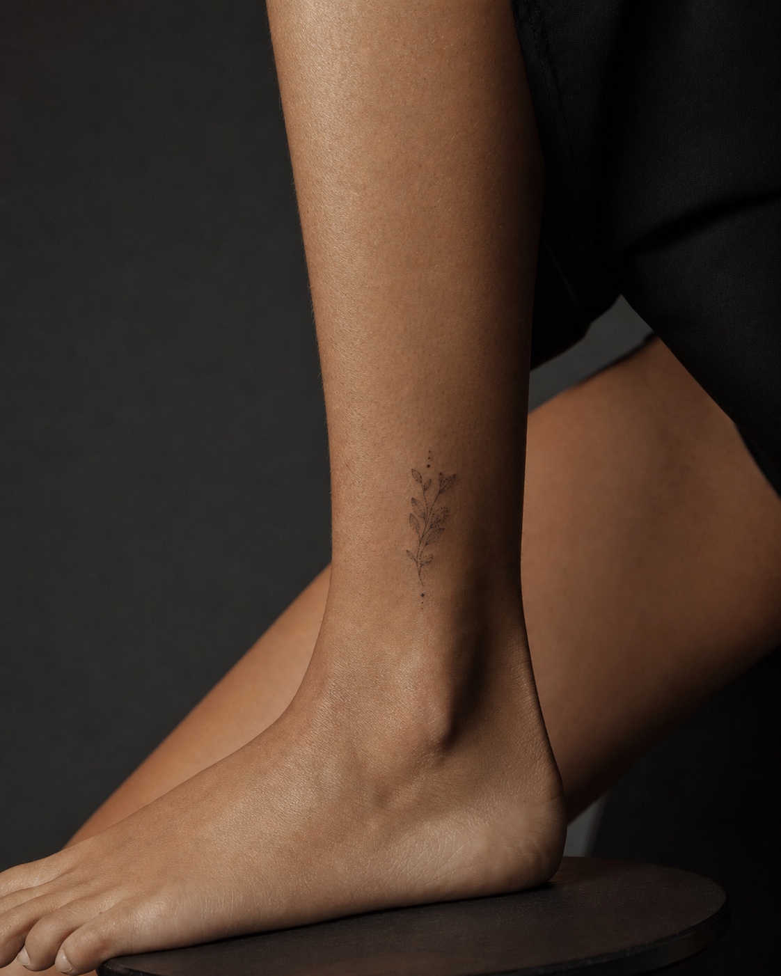 Small dotwork ankle botanical tattoo Small dotwork ankle tattoo with minimalist botanical sprig and tiny geometric dots. | Sky Rye Design Small dotwork ankle tattoo with minimalist botanical sprig and tiny geometric dots.