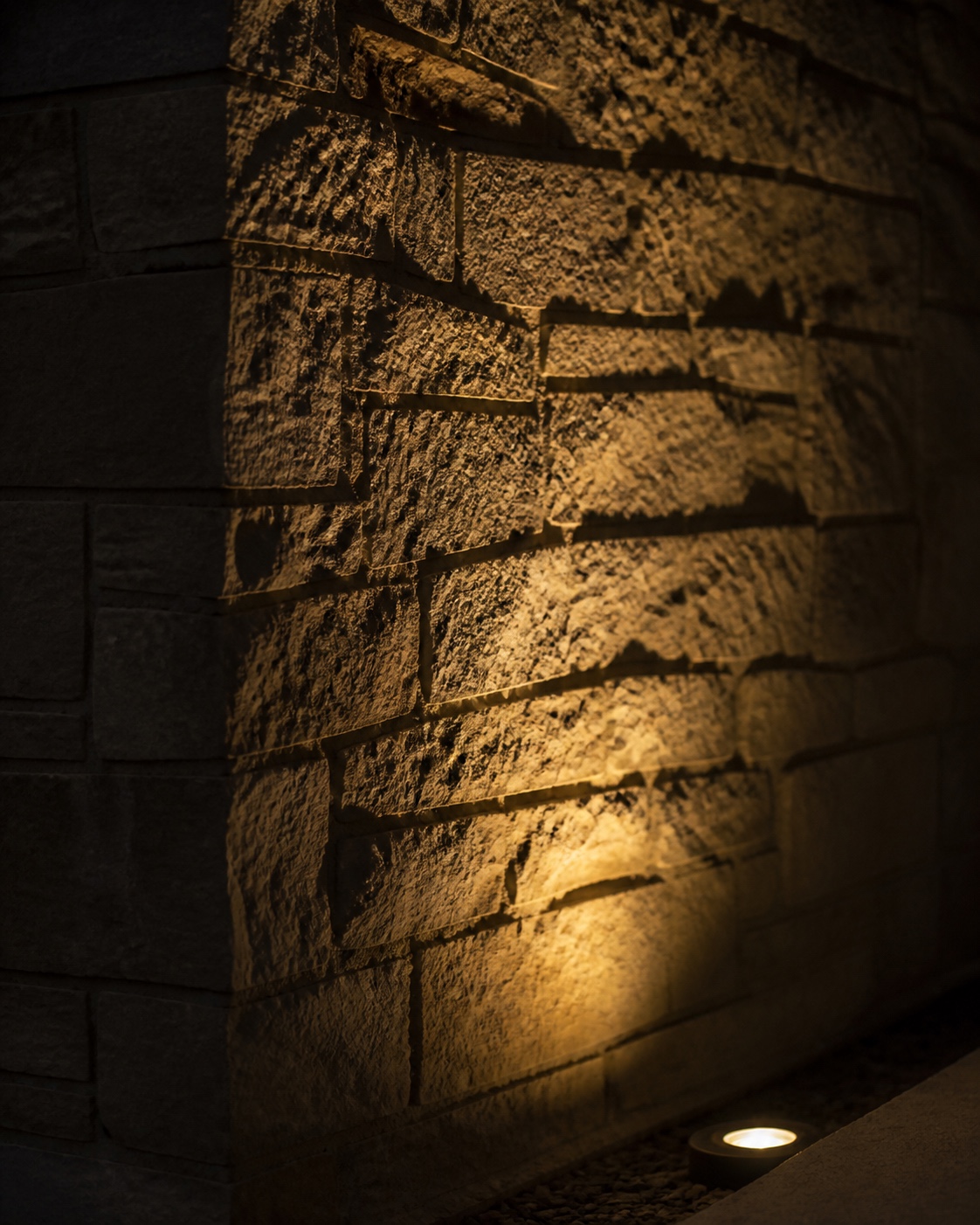 Uplighting grazing stone facade texture Warm uplight grazing a stone facade and revealing texture, mortar shadows, and material depth. | Sky Rye Design Warm uplight grazing a stone facade and revealing texture, mortar shadows, and material depth.