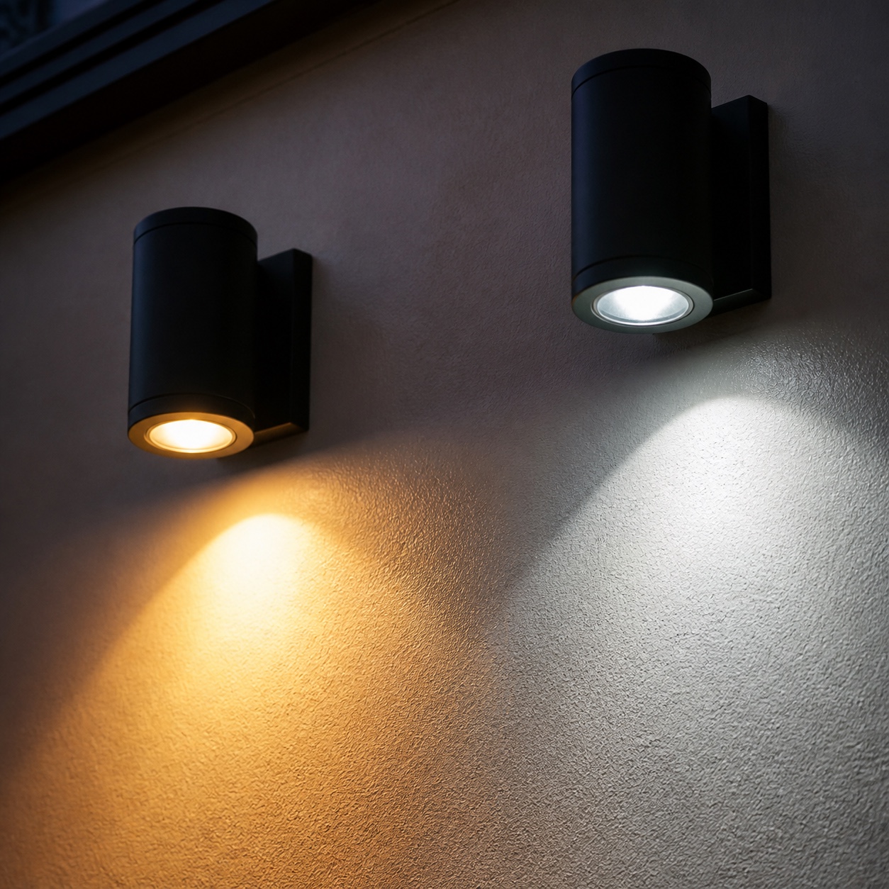 Warm and cool exterior light temperature comparison Two identical exterior fixtures showing warm amber light beside cooler blue-white light on the same wall. | Sky Rye Design Two identical exterior fixtures showing warm amber light beside cooler blue-white light on the same wall.