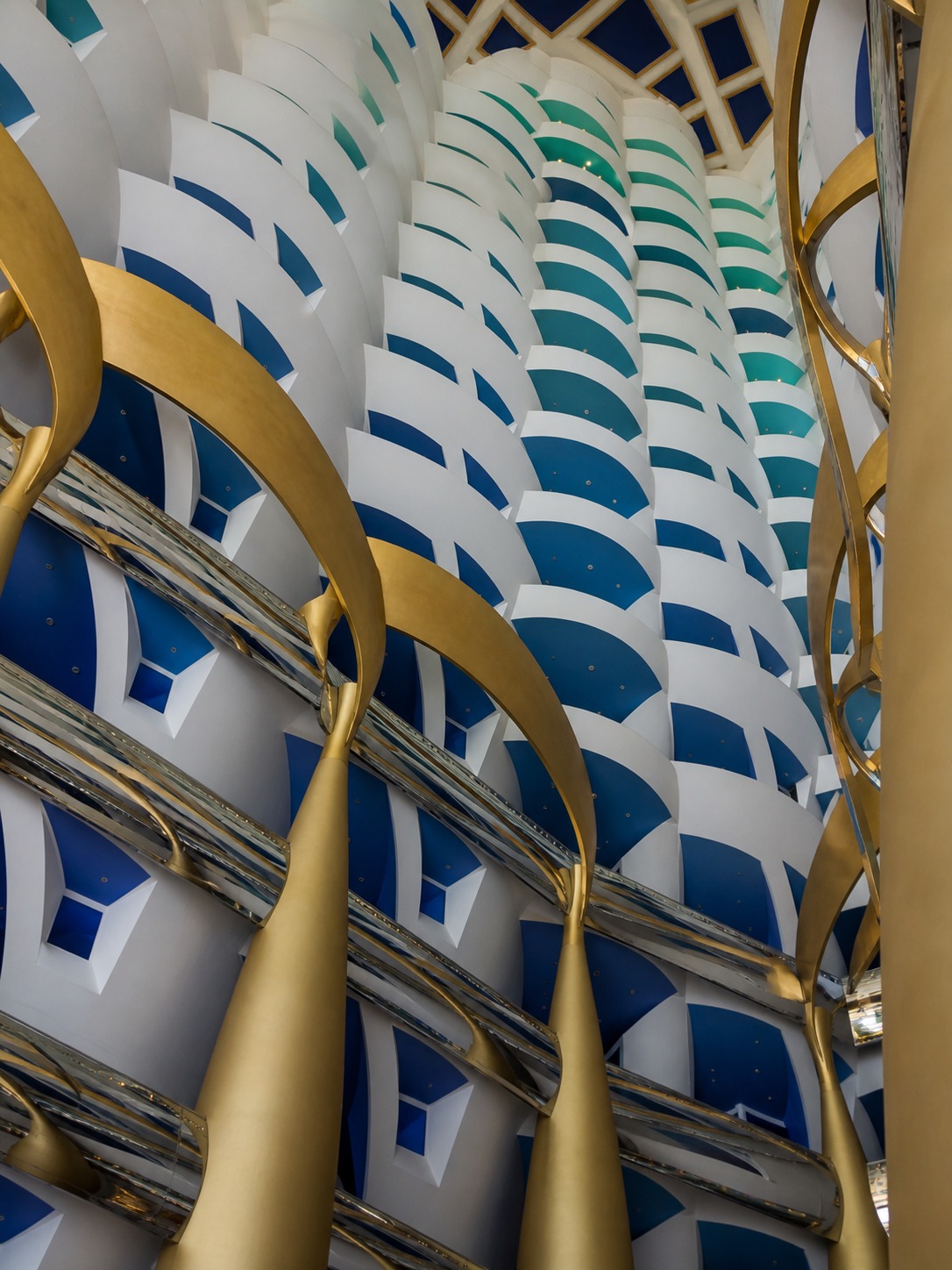 Interior view looking up through the tall central atrium of Burj Al Arab.