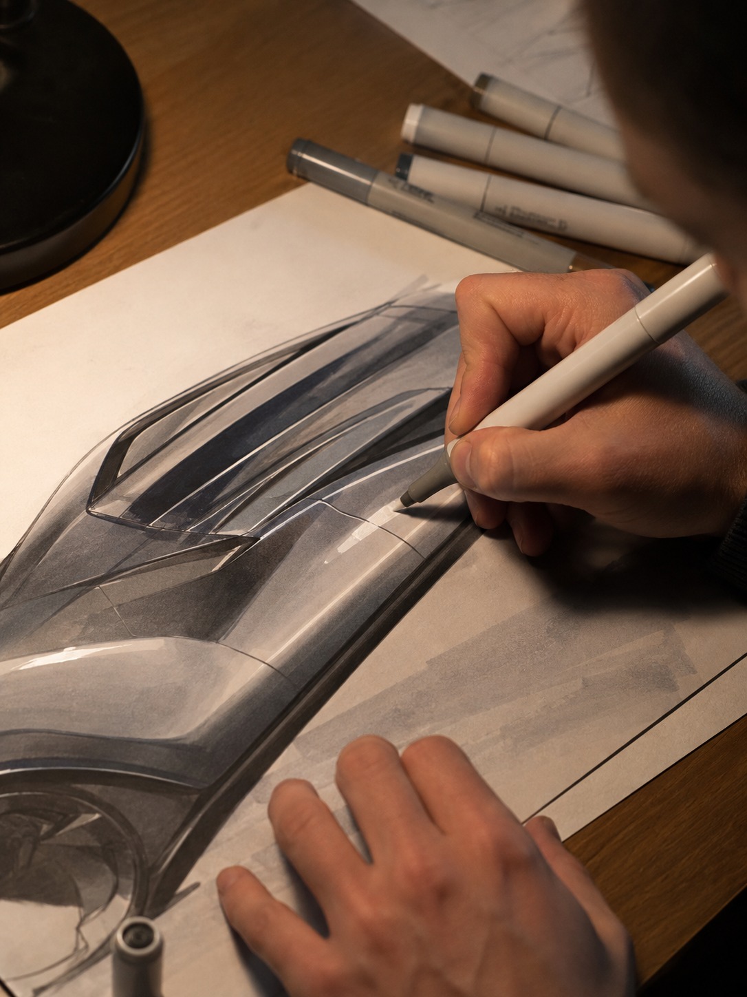 Rendering hard-edged highlights on a car sketch Hands using alcohol markers to render crisp highlight bands on a car sketch over textured paper. | Sky Rye Design Hands using alcohol markers to render crisp highlight bands on a car sketch over textured paper.