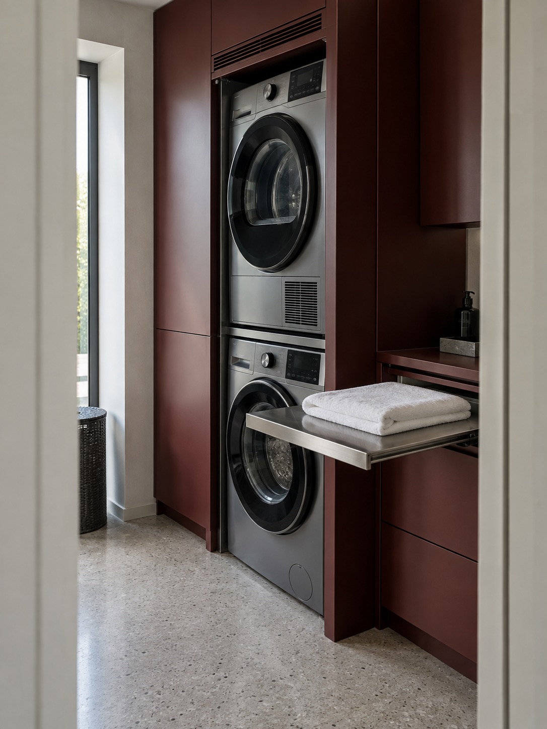 Compact laundry closet Stacked graphite washer and dryer with a pull-out stainless-steel shelf | Sky Rye Design Stacked graphite washer and dryer with a pull-out stainless-steel shelf