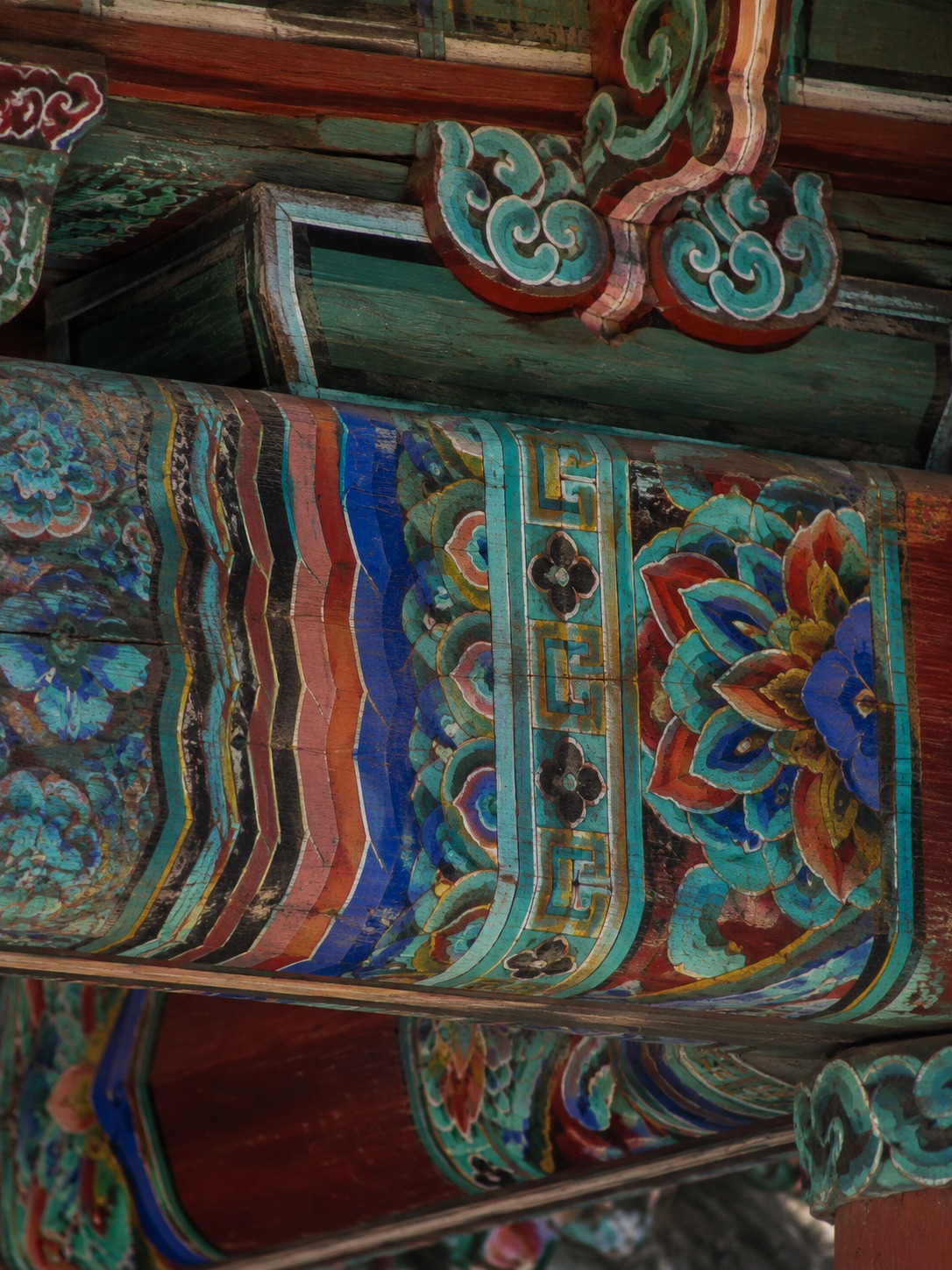 Close detail of aged dancheong painting on a Korean temple beam.