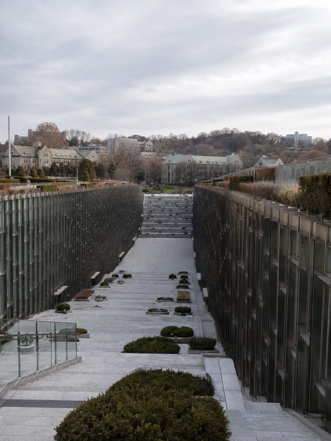 Ewha Womans University sunken terraced campus walkway between two building masses.