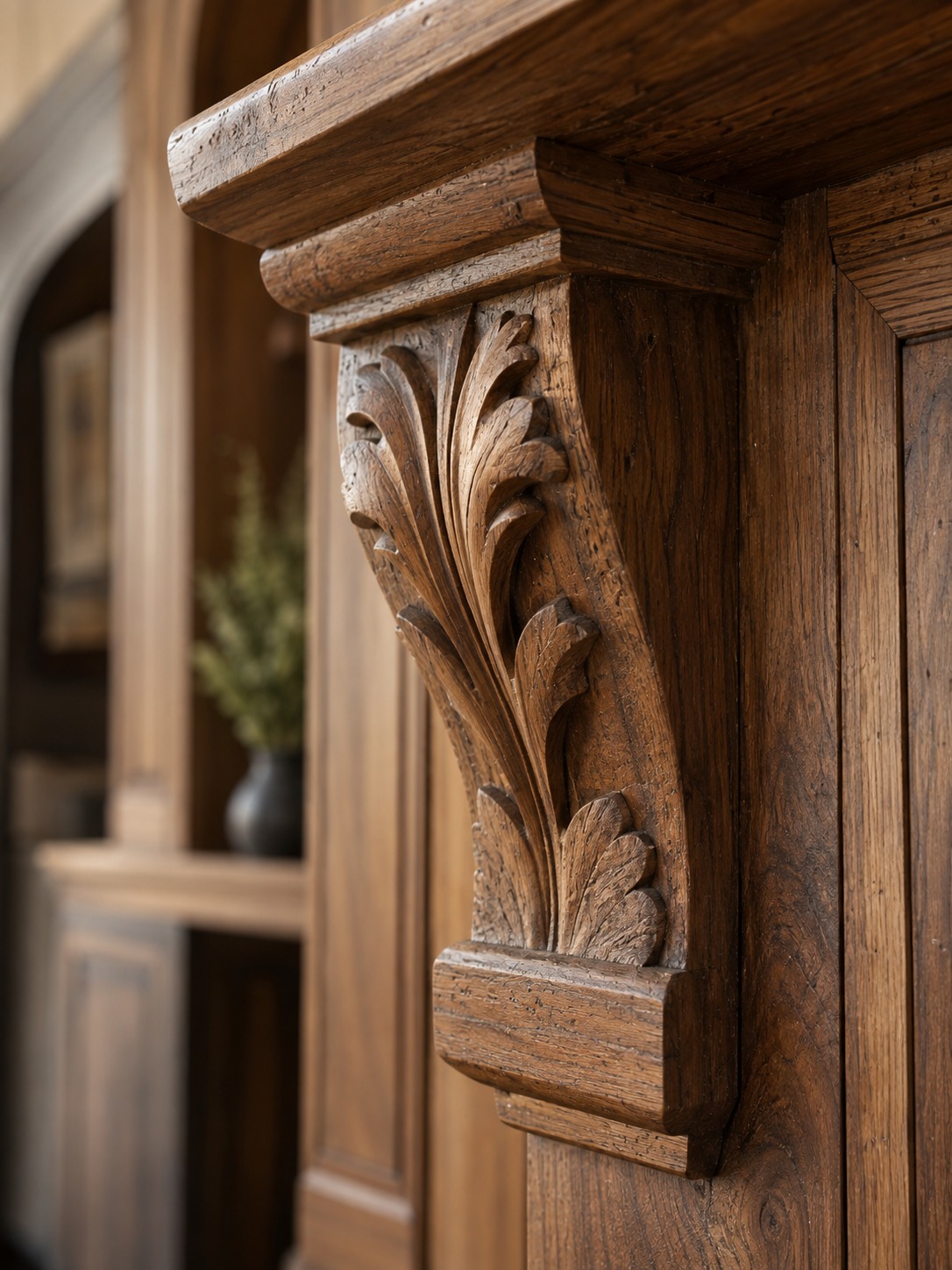 Close-up of hand-carved wood detail on custom millwork in warm side light
