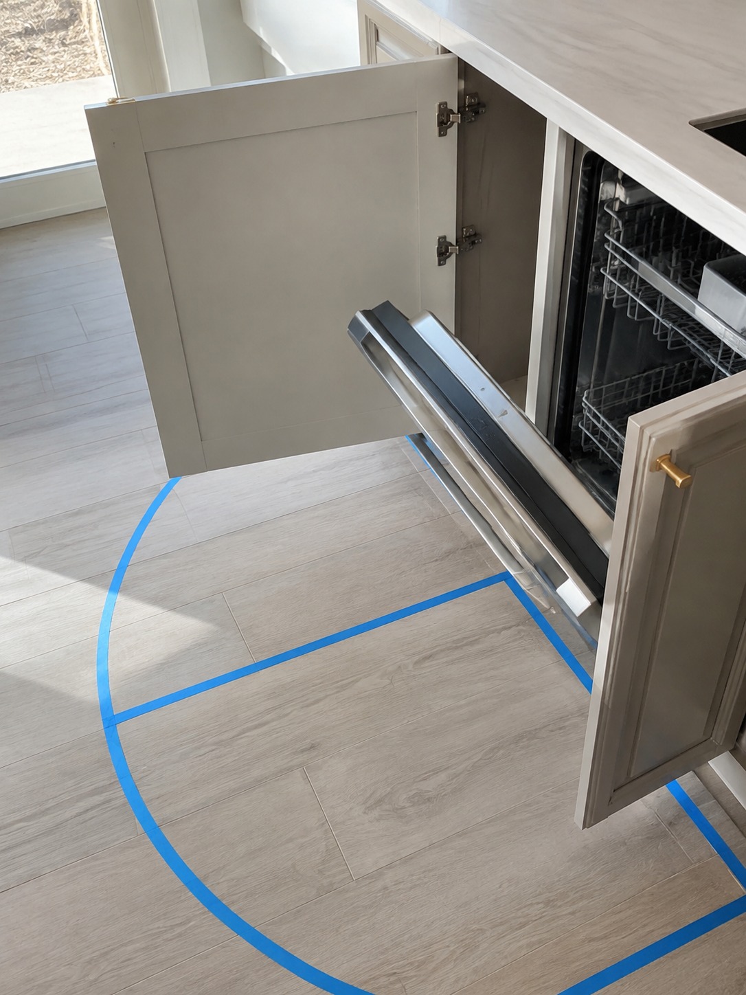 Kitchen appliance door swing clearance cabinet and dishwasher door swing clearance marked on a kitchen floor | Sky Rye Design cabinet and dishwasher door swing clearance marked on a kitchen floor