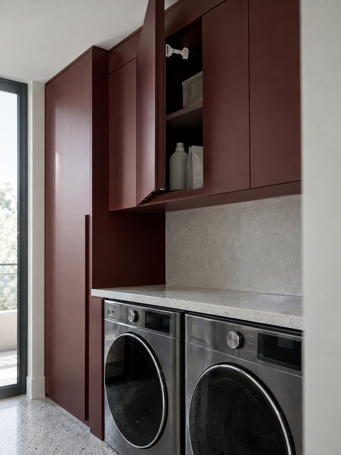 High latched storage Burgundy upper laundry cabinet with a child-resistant latch above the counter | Sky Rye Design Burgundy upper laundry cabinet with a child-resistant latch above the counter