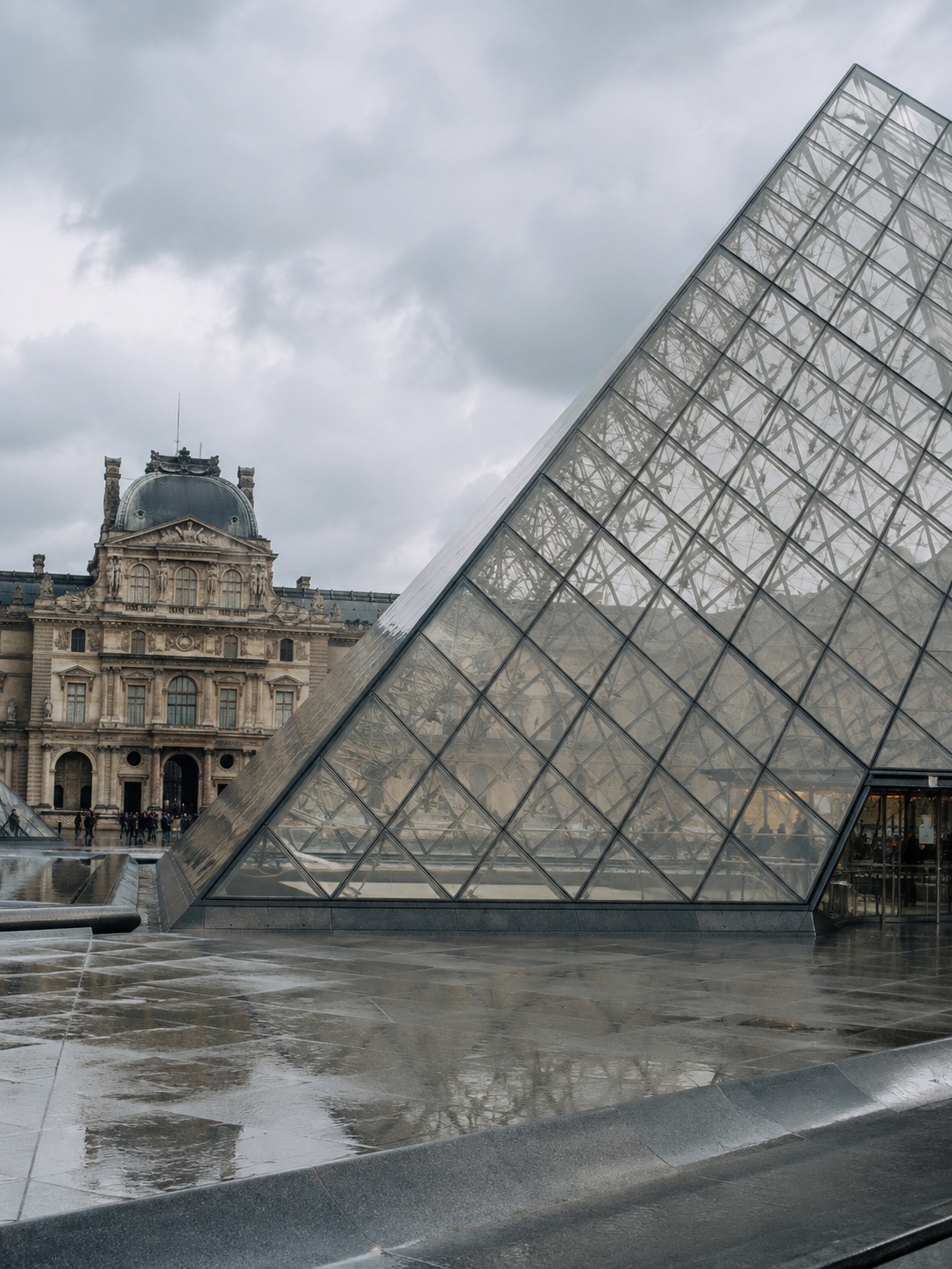 Louvre Glass Pyramid Courtyard Louvre Pyramid in Paris with glass and steel lattice in the museum courtyard. | Sky Rye Design Louvre Pyramid in Paris with glass and steel lattice in the museum courtyard.