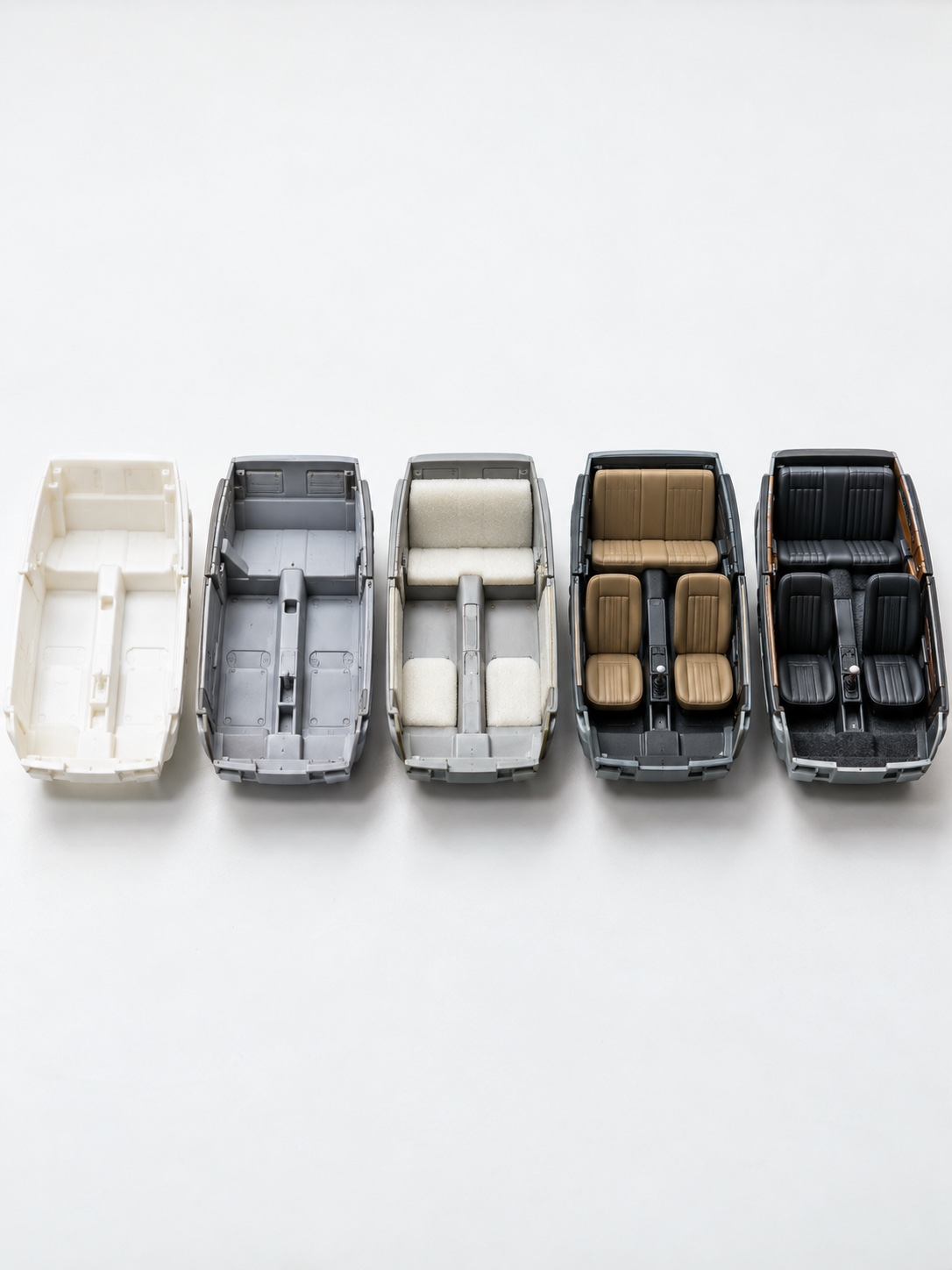 Model car interior build stages Five scale model car interior tubs progressing from bare plastic to finished upholstery | Sky Rye Design Five scale model car interior tubs progressing from bare plastic to finished upholstery