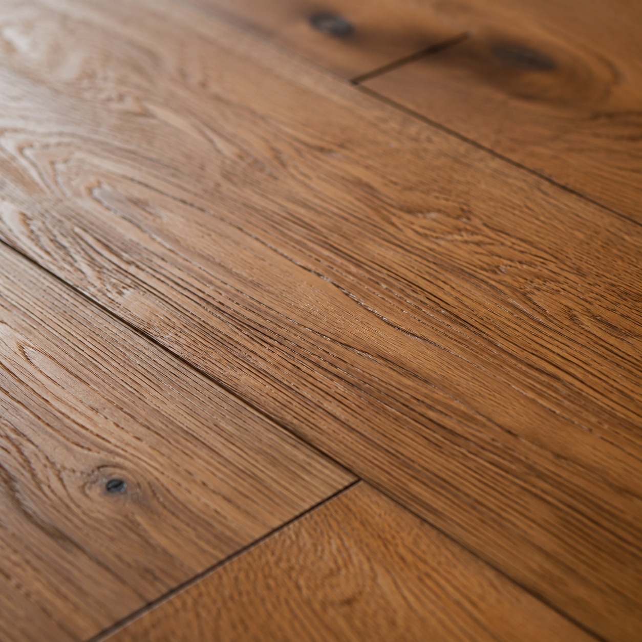 Oak Hardwood Flooring Grain Detail A close detail of oak hardwood flooring showing grain, knots, and plank seams. | Sky Rye Design A close detail of oak hardwood flooring showing grain, knots, and plank seams.