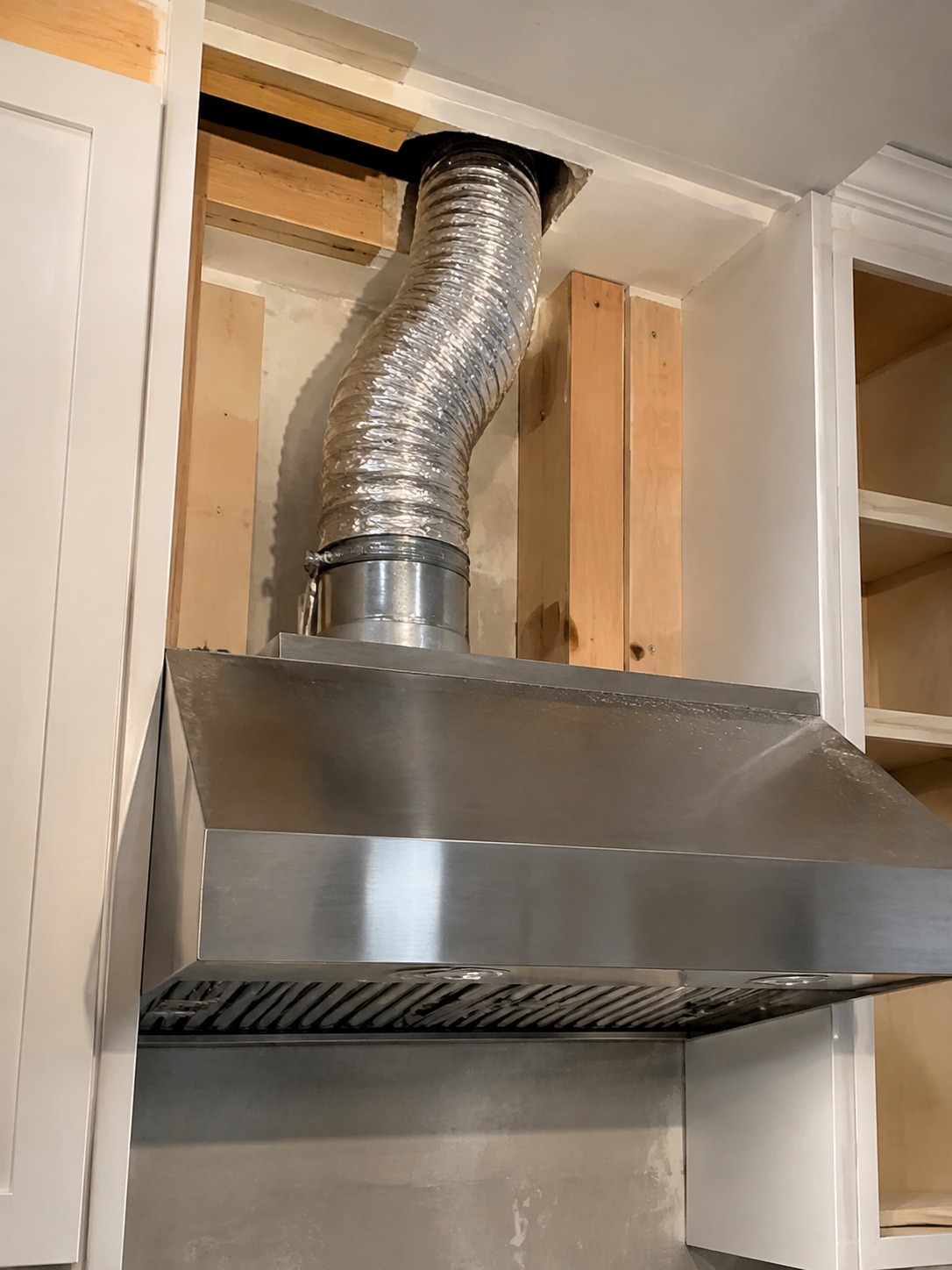 Range hood ventilation ductwork installation range hood ventilation ductwork being installed in a kitchen | Sky Rye Design range hood ventilation ductwork being installed in a kitchen