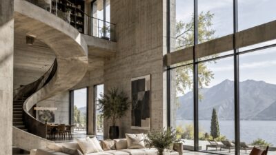 Double-height living room with a sculptural spiral staircase and glass facade