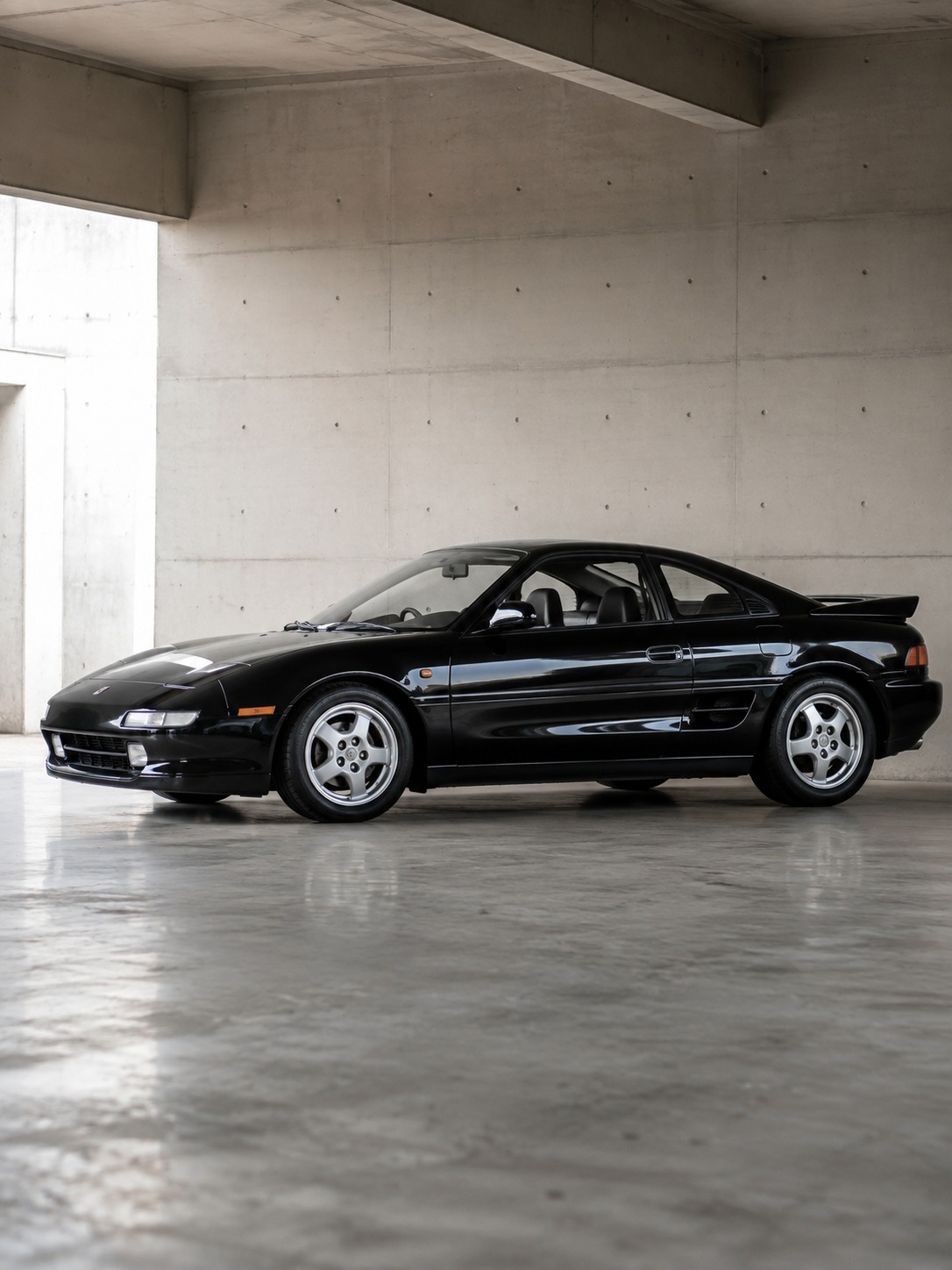 Toyota MR2 low compact studio stance A Toyota MR2 photographed from a low angle in a concrete studio to emphasize its compact mid-engine stance. | Sky Rye Design A Toyota MR2 photographed from a low angle in a concrete studio to emphasize its compact mid-engine stance.