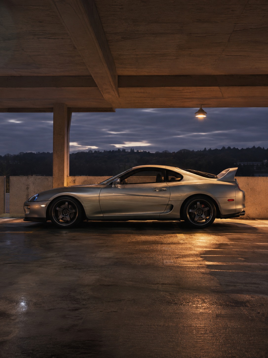 Toyota Supra profile in an underground garage A Toyota Supra in profile with wide rear haunches lit inside an empty underground garage. | Sky Rye Design A Toyota Supra in profile with wide rear haunches lit inside an empty underground garage.