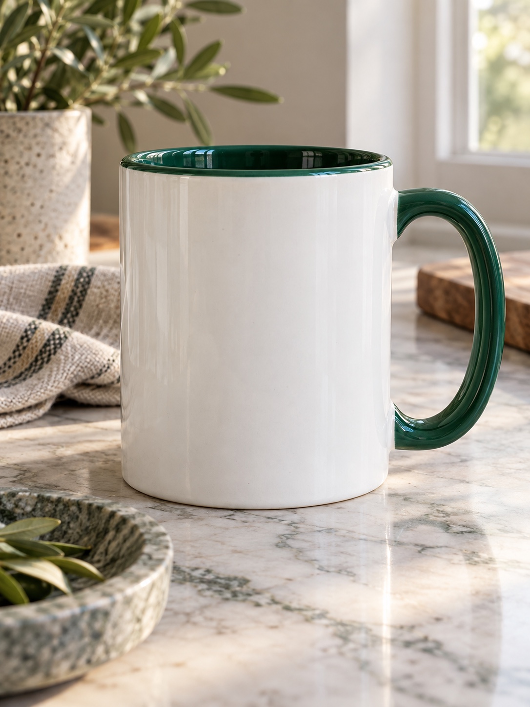 White ceramic mug with a forest green rim and handle on a marble countertop