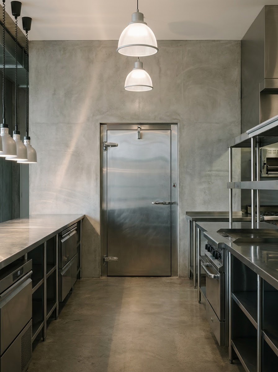 Walk-In Freezer in a Commercial Kitchen Stainless steel walk-in freezer door integrated into a modern commercial kitchen wall | Sky Rye Design Stainless steel walk-in freezer door integrated into a modern commercial kitchen wall