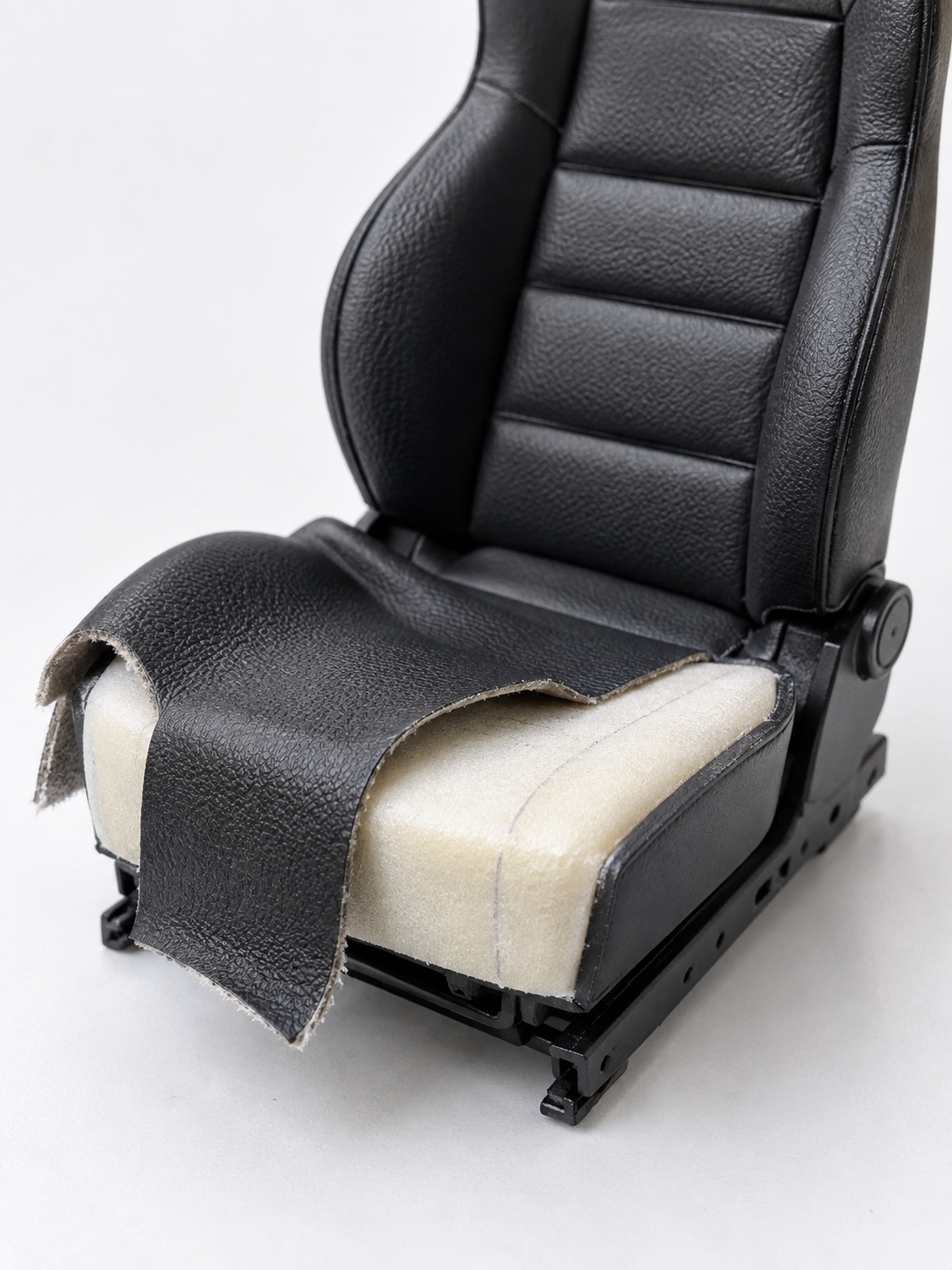 Wrapping miniature leather over a model car seat Thin miniature leather being wrapped over a padded 1/24 scale model car seat | Sky Rye Design Thin miniature leather being wrapped over a padded 1/24 scale model car seat