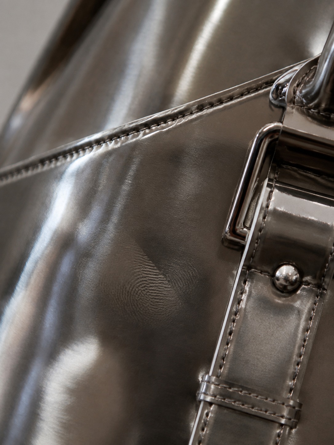Metallic bag texture Close-up of a glossy metallic handbag surface | Sky Rye Design Close-up of a glossy metallic handbag surface