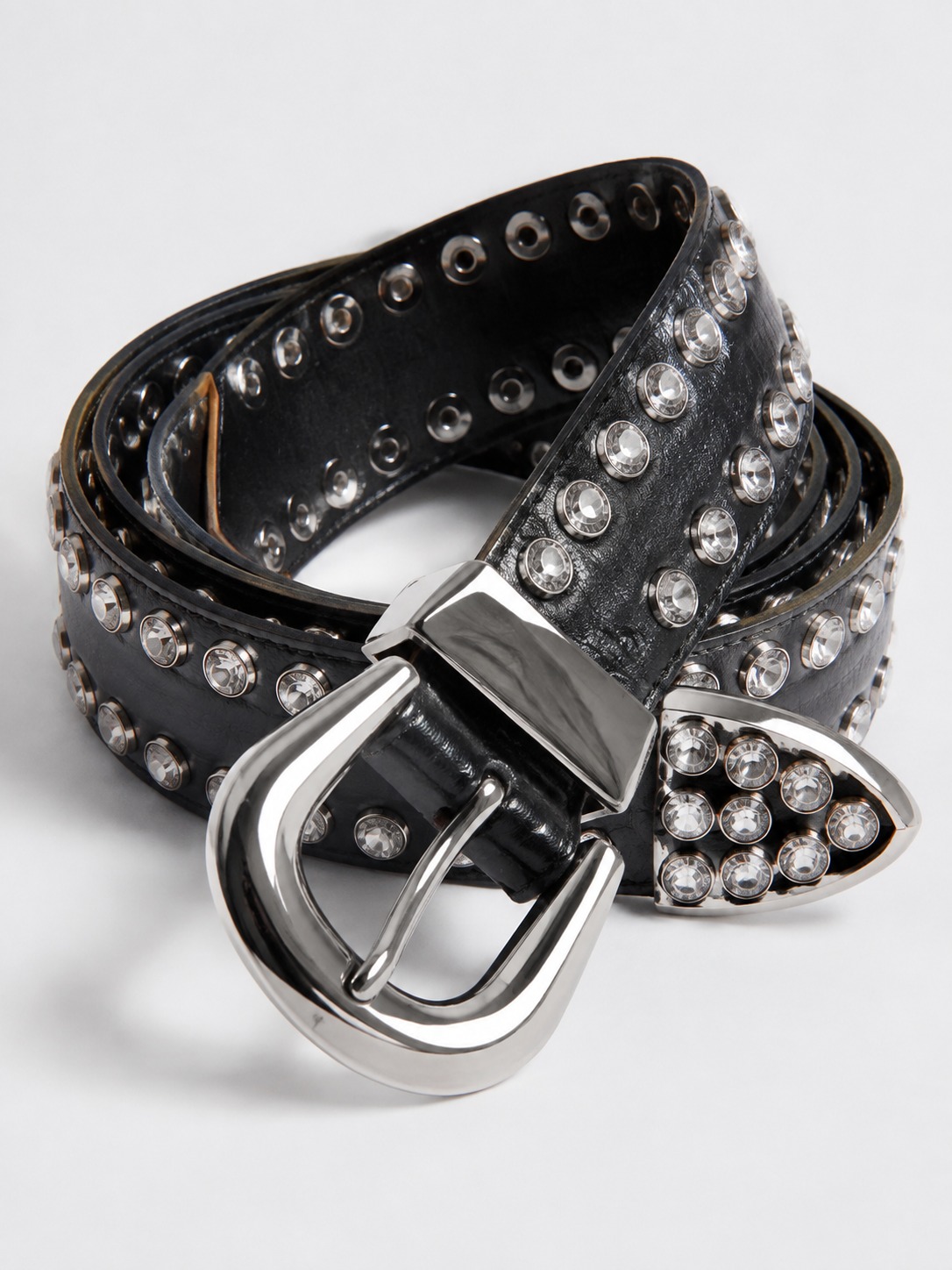 Rhinestone belt silver buckle Rhinestone belt with an oversized silver buckle on a white surface | Sky Rye Design Rhinestone belt with an oversized silver buckle on a white surface