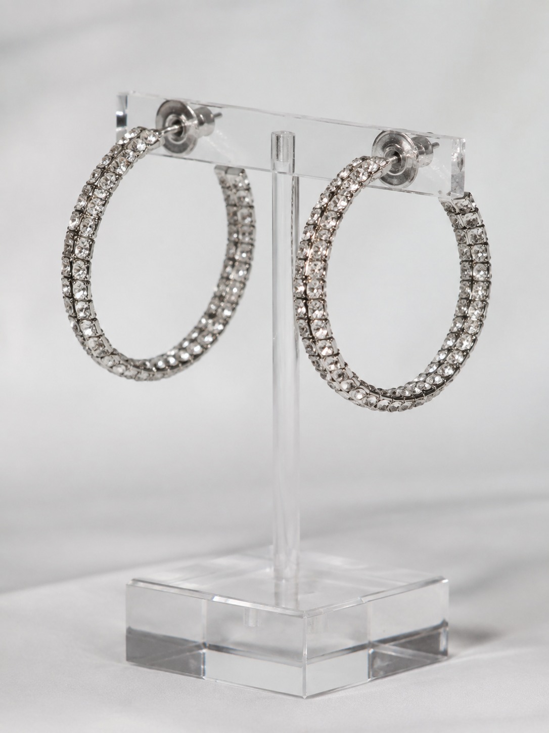 Rhinestone hoop earrings Pair of rhinestone hoop earrings on a clear acrylic stand | Sky Rye Design Pair of rhinestone hoop earrings on a clear acrylic stand