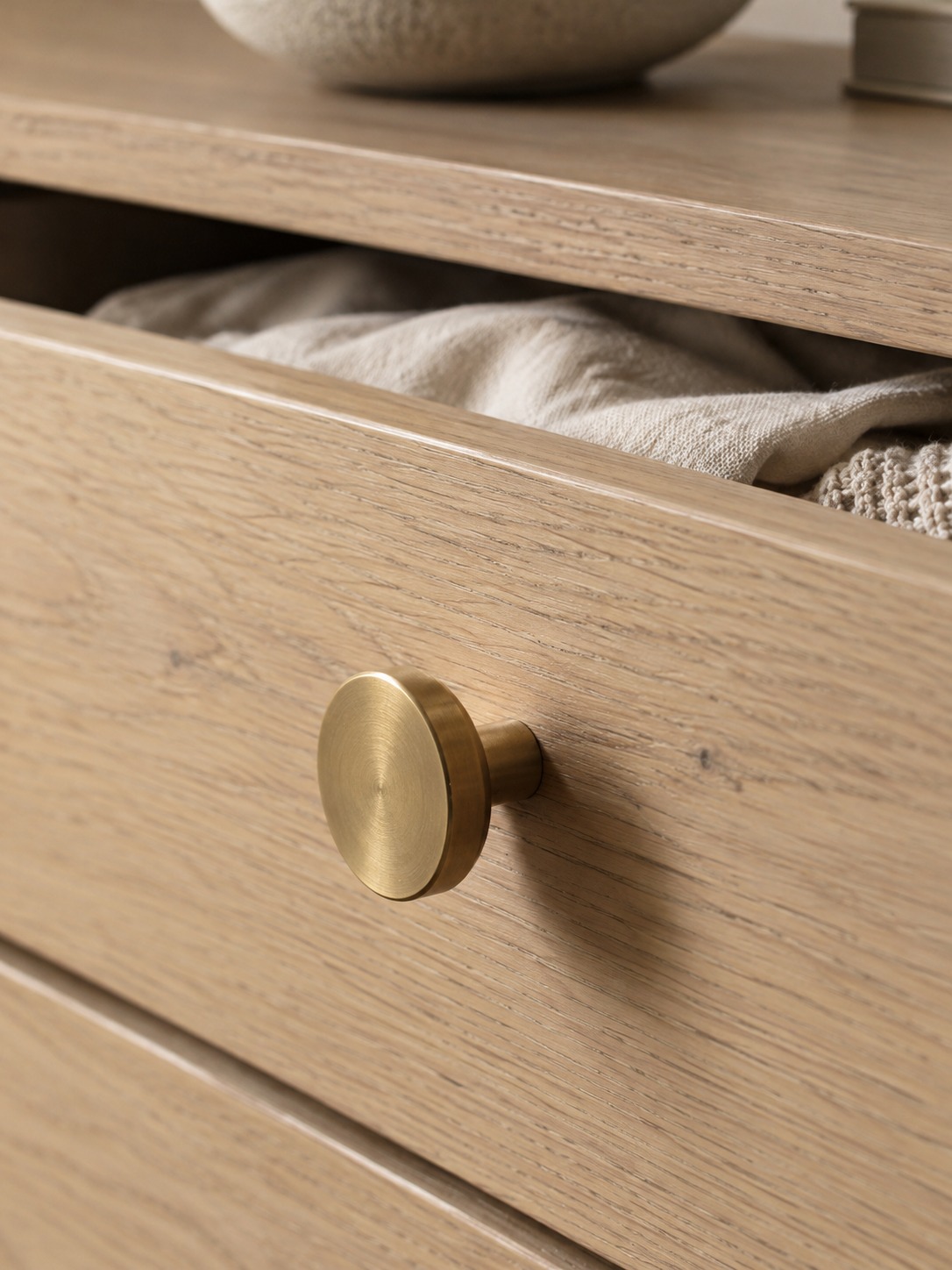 Brass pull oak nursery dresser Matte brass drawer pull on a slightly open pale oak dresser | Sky Rye Design Matte brass drawer pull on a slightly open pale oak dresser
