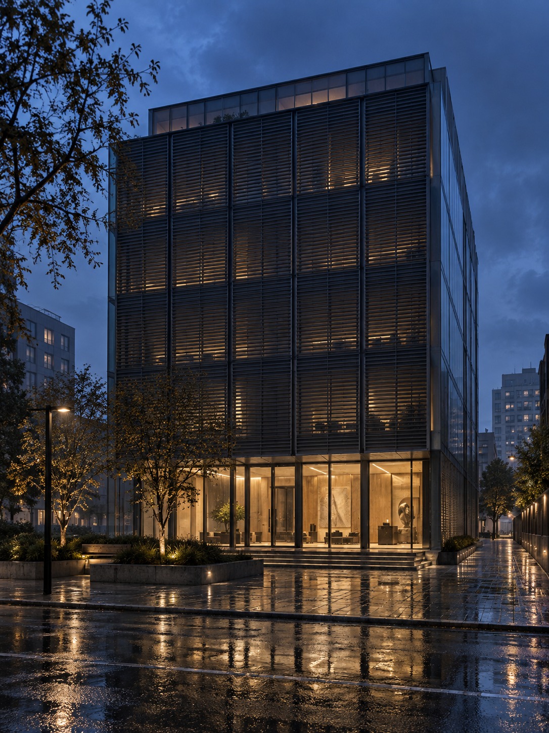 Closed exterior louvers above a lit lobby reflected on wet pavement