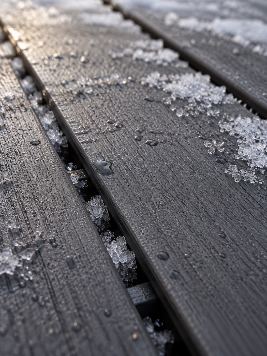 Composite Deck Board Spacing and Frost Melting frost between properly spaced dark composite deck boards | Sky Rye Design Melting frost between properly spaced dark composite deck boards