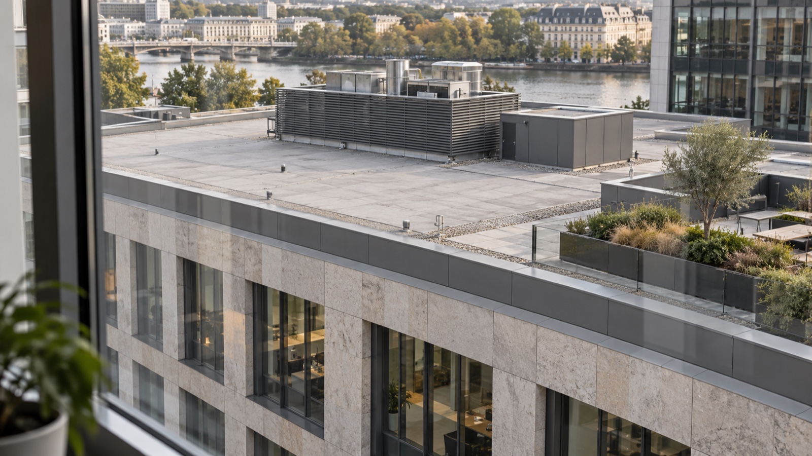 The roof as a visible fifth facade View from an upper-floor office window down onto a neat commercial roofscape with coordinated color, straight copings and a defined walkway | Sky Rye Design View from an upper-floor office window down onto a neat commercial roofscape with coordinated color, straight copings and a defined walkway