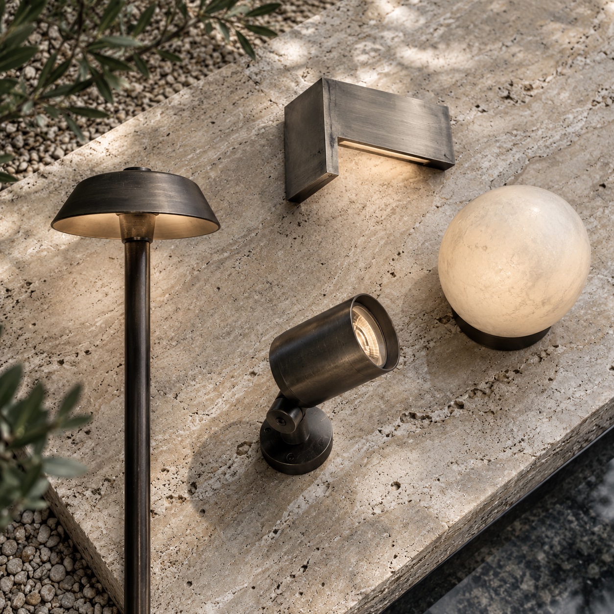 Garden lighting fixtures arranged on travertine for comparison
