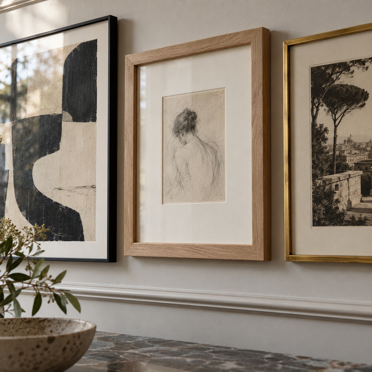 Close view of black metal, pale oak and brushed brass picture frames with different visual weights