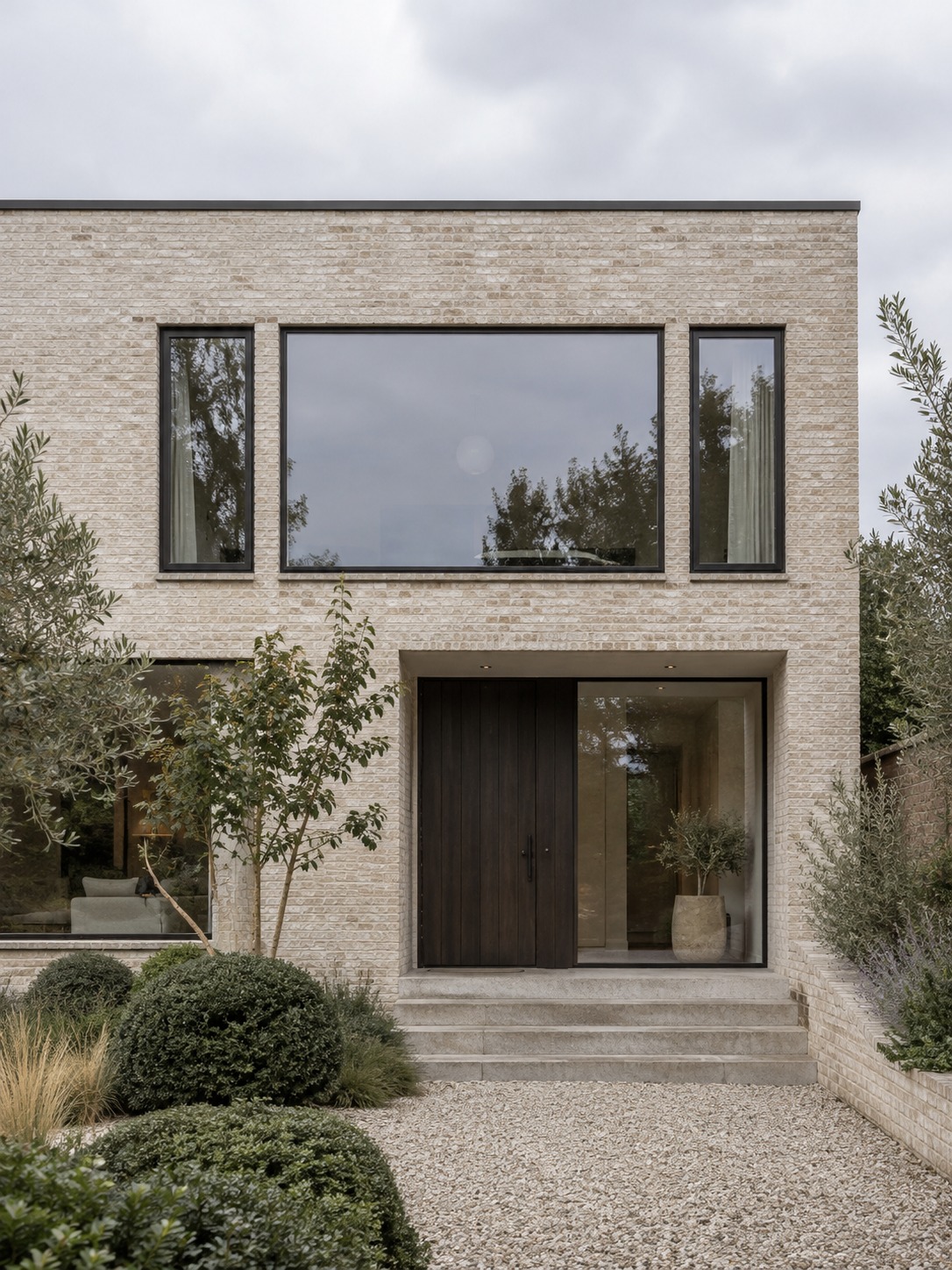 Picture casement modern facade Modern brick house with a picture window flanked by narrow casements in matching black frames | Sky Rye Design Modern brick house with a picture window flanked by narrow casements in matching black frames