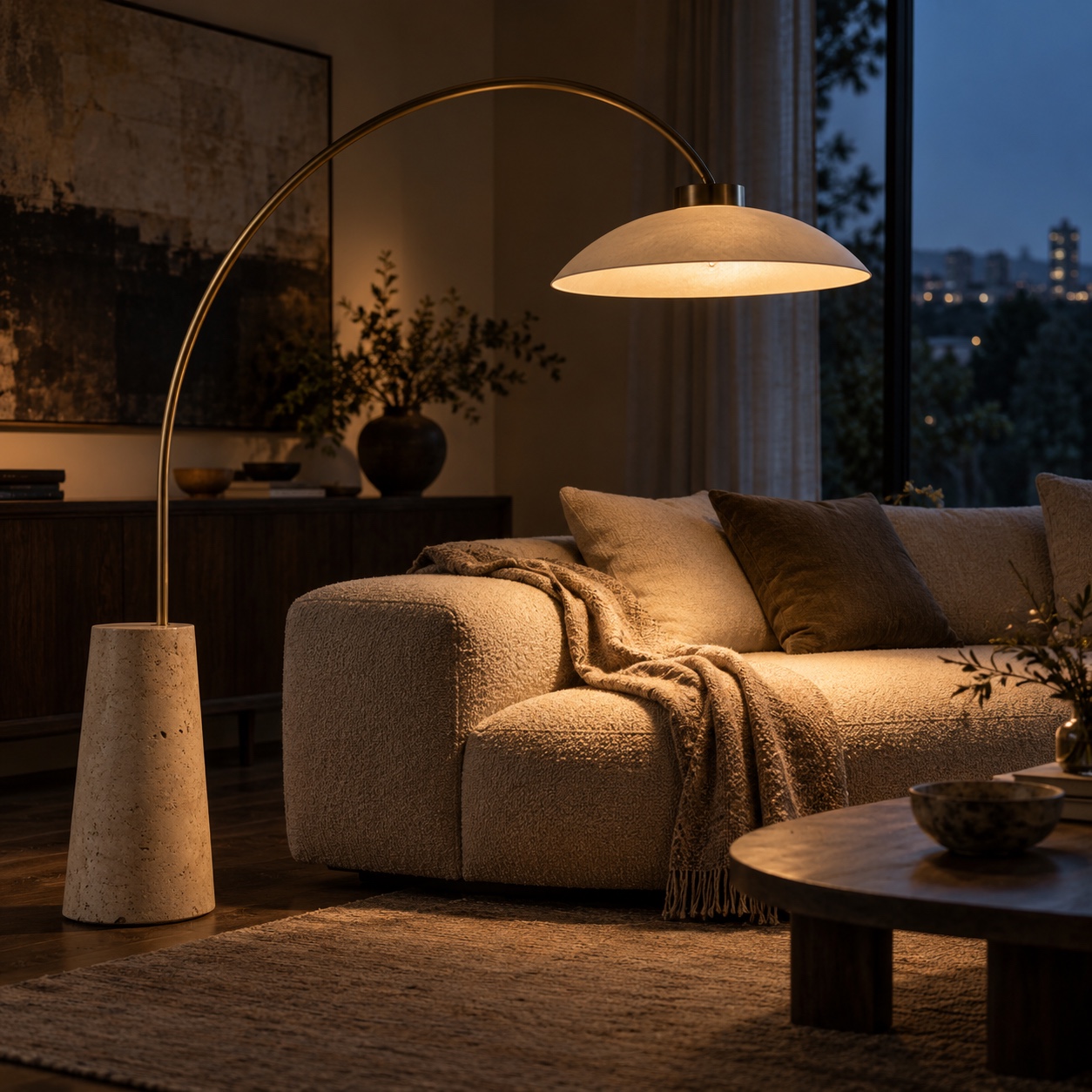 Original arched floor lamp casting warm reading light over a low upholstered sofa